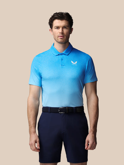 Man wearing a light blue polo shirt with a Castore logo on a beige background