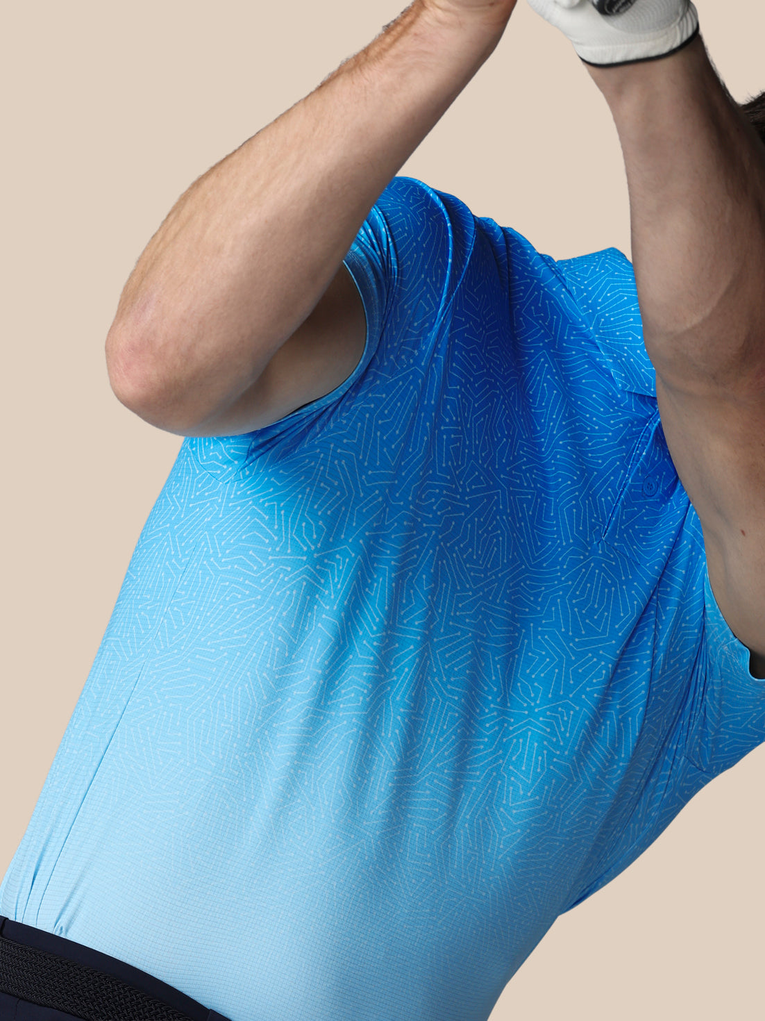 Person wearing a blue sleeveless shirt on a beige background