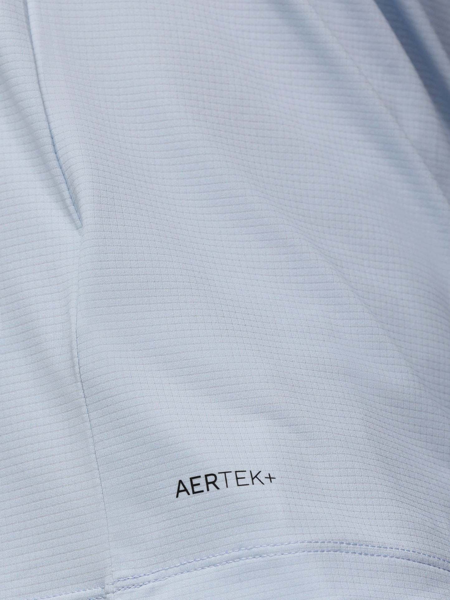 Close-up of a light gray fabric with 'AERTEK+' branding.