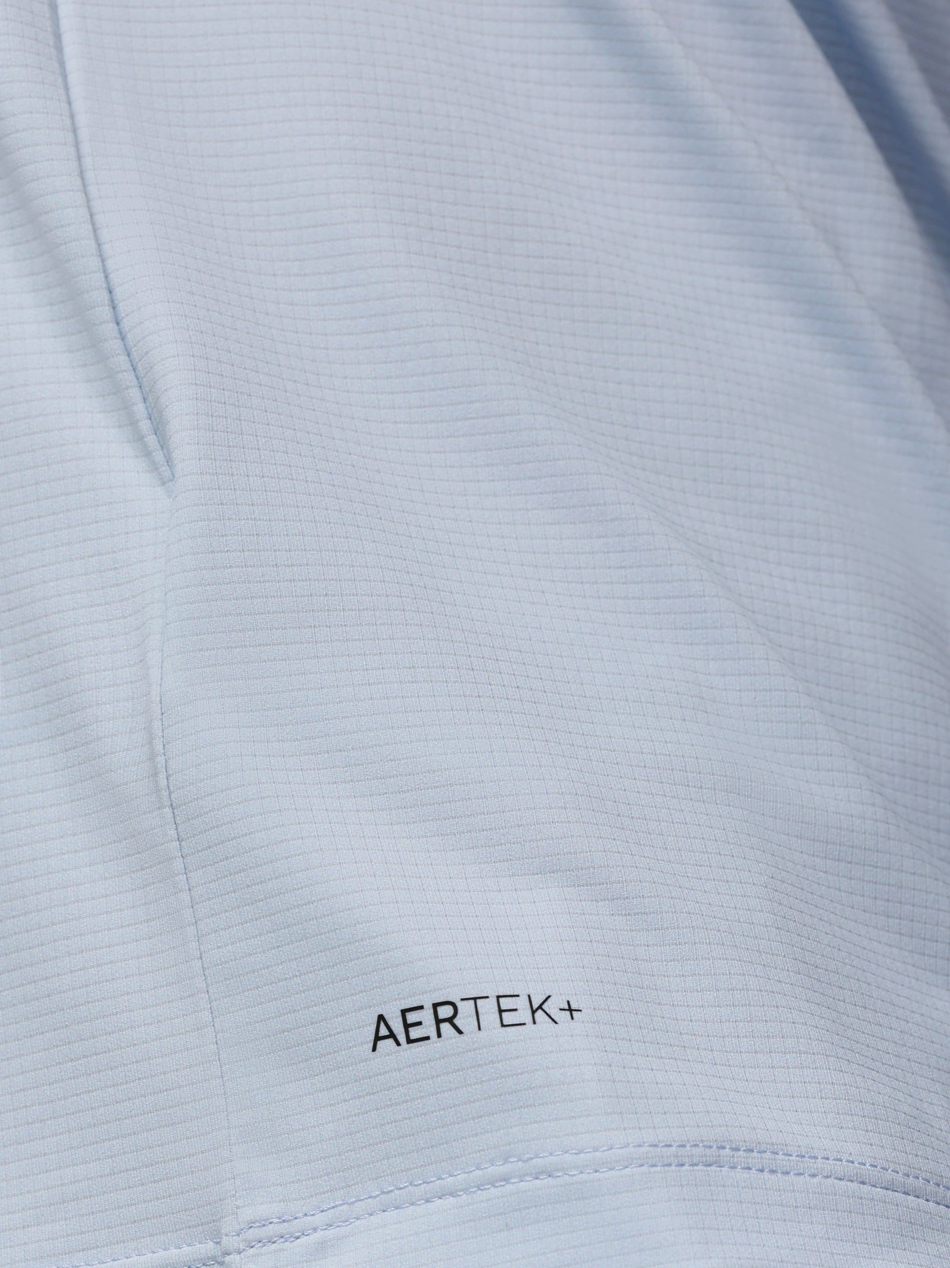 Close-up of a light gray fabric with 'AERTEK+' branding.