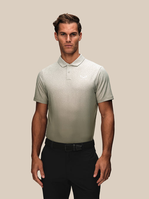 Male model wearing a cream golf short sleeve polo with a subtle geometric pattern across the chest