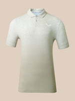 A short-sleeve polo shirt with a subtle tonal geometric pattern, featuring a small embroidered logo on the left chest, displayed against a solid beige background.
