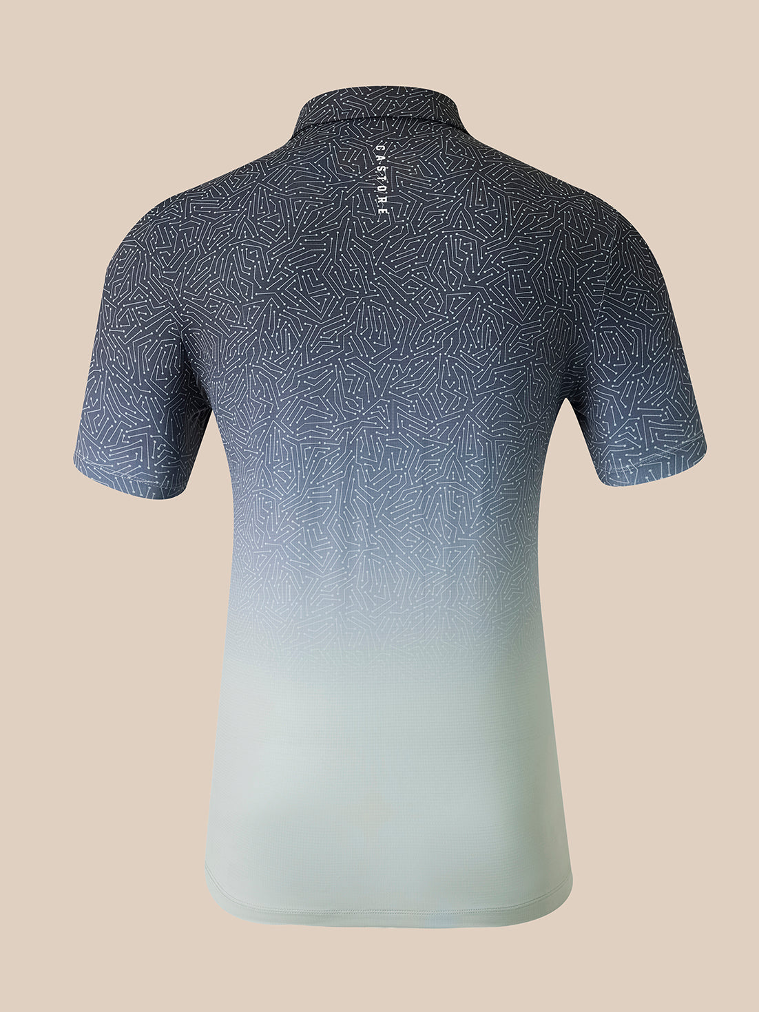 A short-sleeve polo shirt shown from the back, featuring a dark gray and blue geometric pattern that fades into a light mint green at the hem, set against a solid beige background.