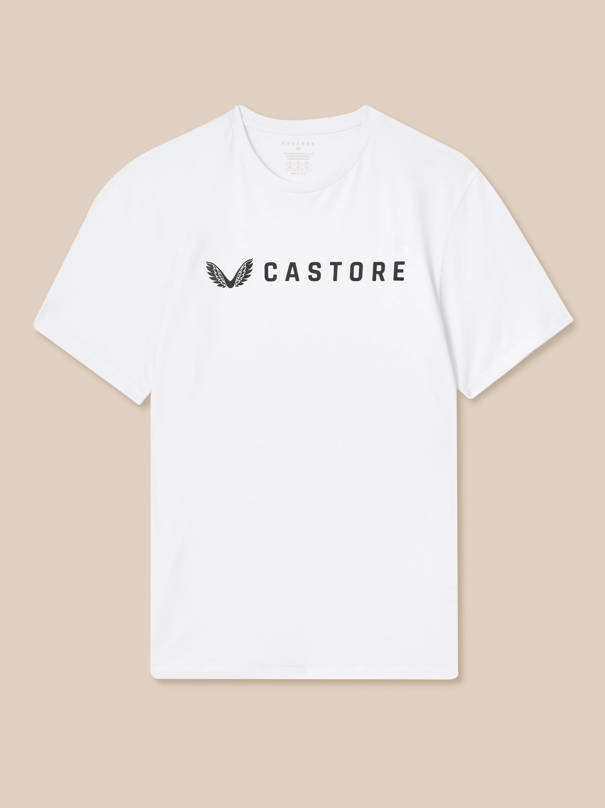 White t-shirt with 'CASTORE' logo on a beige background