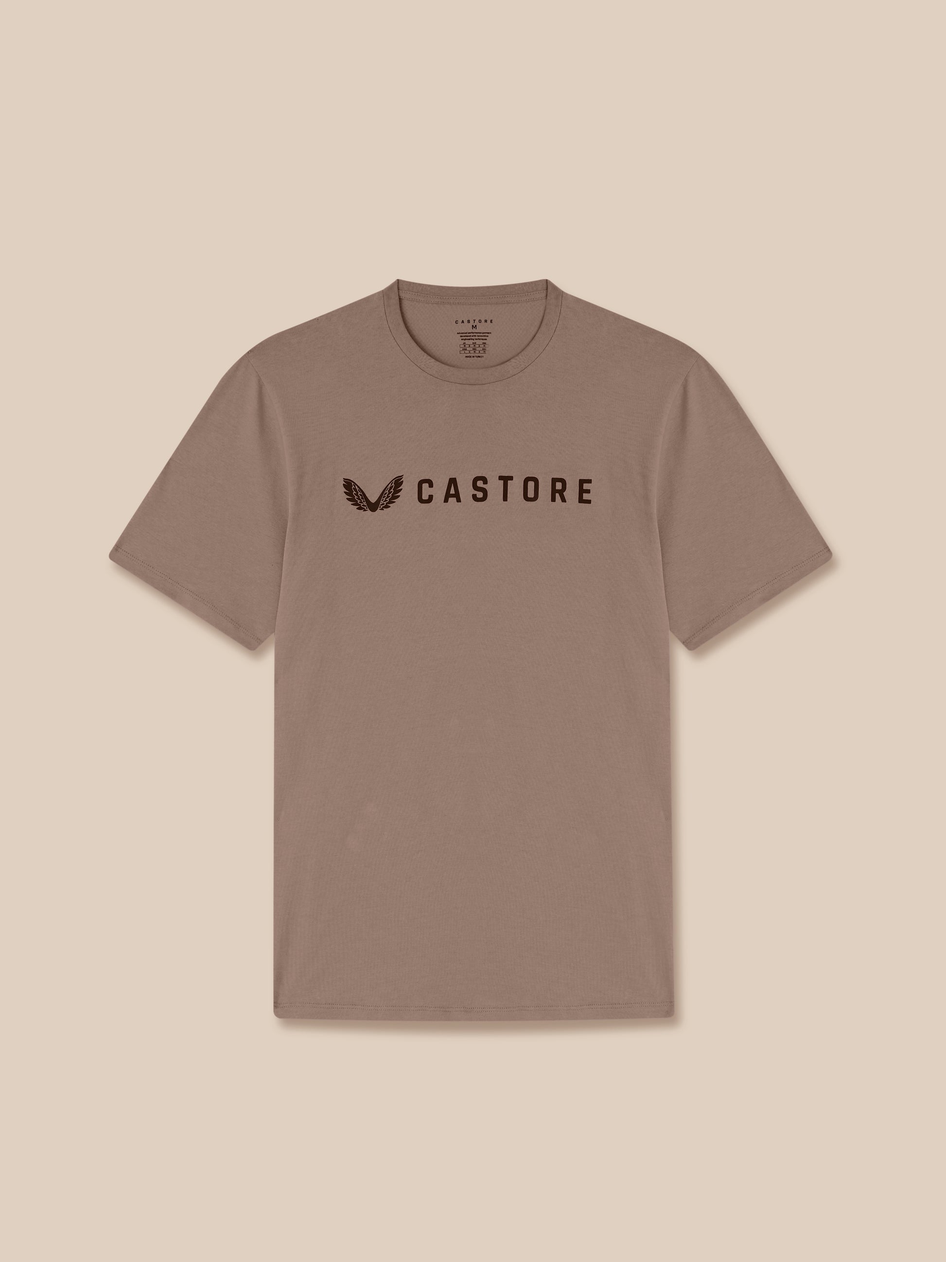 Brown t-shirt with 'CASTORE' logo on a beige background