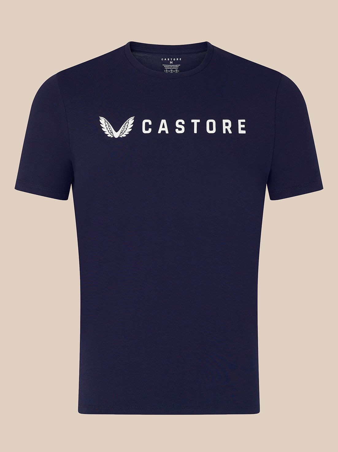 A navy blue short-sleeve crewneck t-shirt with a white Castore wing logo and brand name printed across the chest, displayed against a solid beige background.