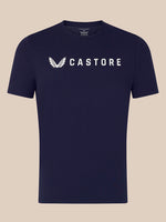 A navy blue short-sleeve crewneck t-shirt with a white Castore wing logo and brand name printed across the chest, displayed against a solid beige background.