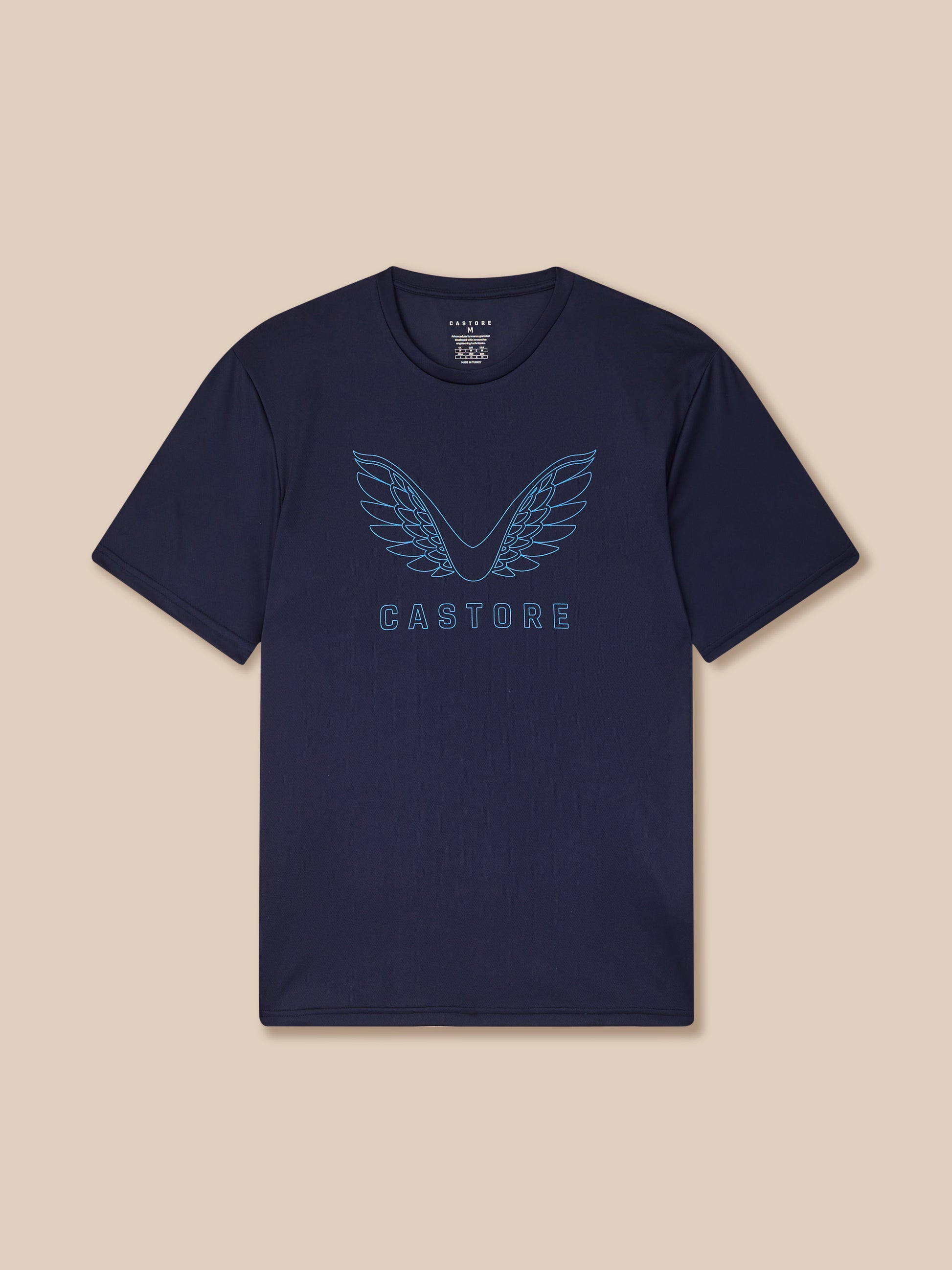 Navy t-shirt with 'Castore' logo on a beige background