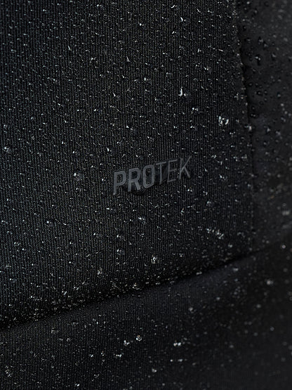 Close up of water droplets beading on black Protek fabric of the gilet.