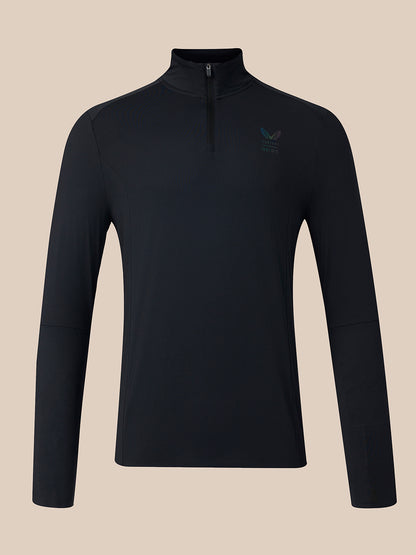 A black long-sleeve quarter-zip pullover top with a small embroidered logo on the left chest, displayed on a solid beige background.