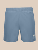 Light blue athletic shorts with an elastic waistband and a small white wing logo on the lower left leg, shown against a solid beige background.