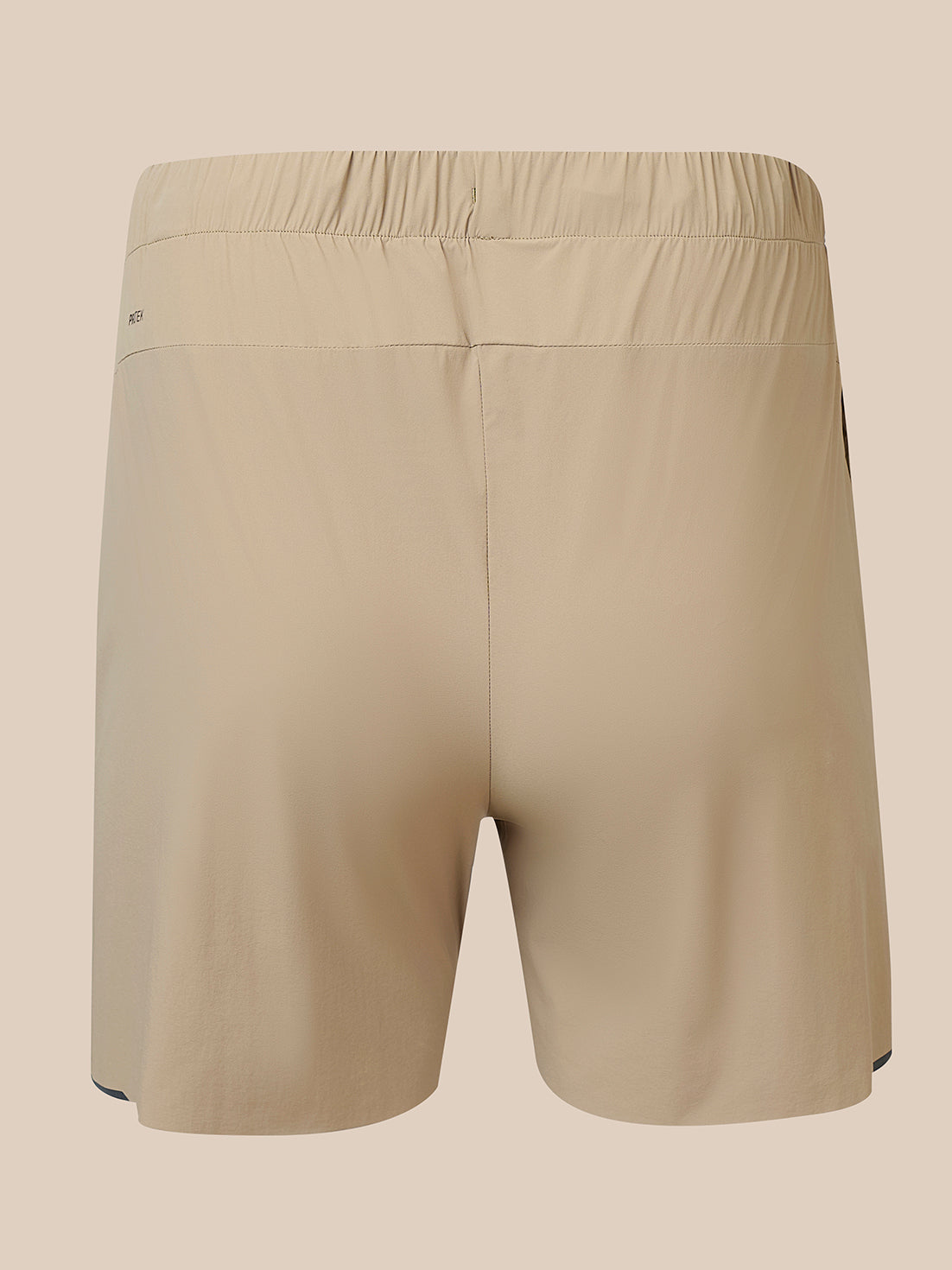 Beige athletic shorts with an elastic waistband, shown from the back on a solid beige background.