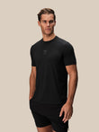 Front view of a male model wearing the black Reiss x Castore performance short sleeve t shirt with a subtle chest logo.