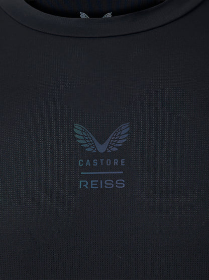 Close-up of a dark navy textured knit top with a subtle tonal Castore Reiss wing logo and text on the chest.