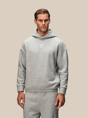Grey oversized hoodie from Reiss x Castore worn by a male model with a small chest logo.