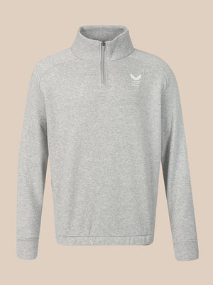 A light gray heathered quarter-zip sweatshirt with a small white winged logo on the left chest, displayed on a solid beige background.