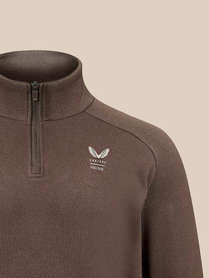 A close-up of a dark brown quarter-zip pullover sweater with a white embroidered winged logo and the brand name 'CASTORE' on the left chest, set against a solid beige background.