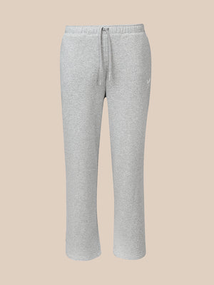 Light heather gray sweatpants with an elastic waistband and drawstring, featuring a small white Castore logo on the left hip, shown against a solid beige background.