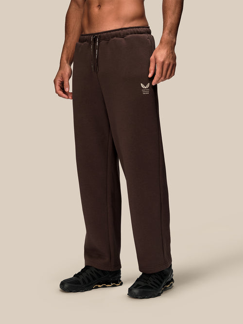 Brown wide leg fleece joggers with drawstring waistband and small logo on the thigh
