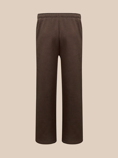 A pair of dark brown sweatpants with a drawstring waist , shown against a solid beige background.