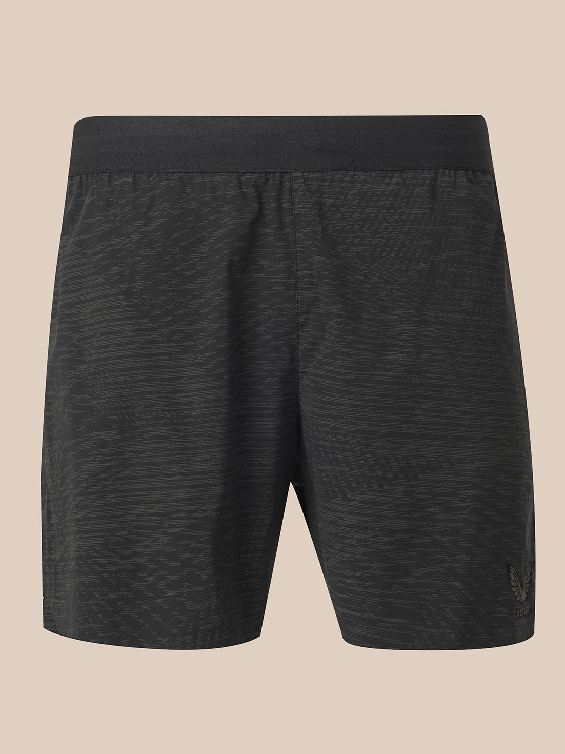 Black athletic shorts with a subtle wavy pattern, shown from the back on a solid beige background.