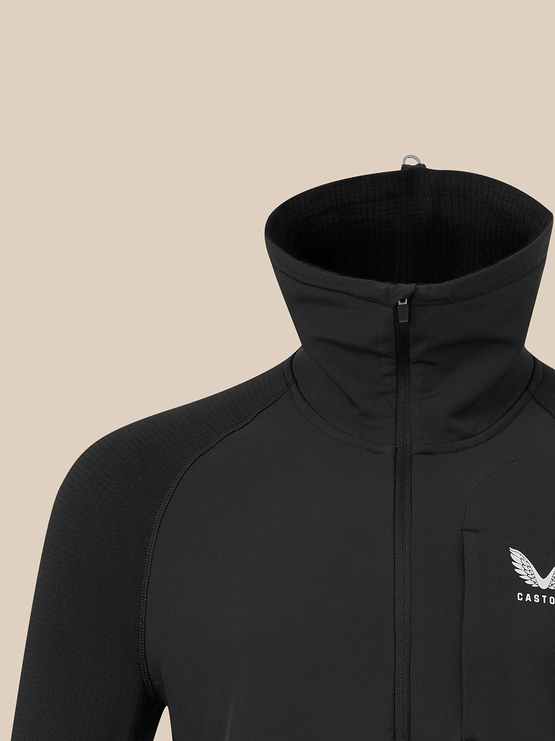 Close-up of black men's thermo top with half zip closure and tall stand collar, left chest logo.