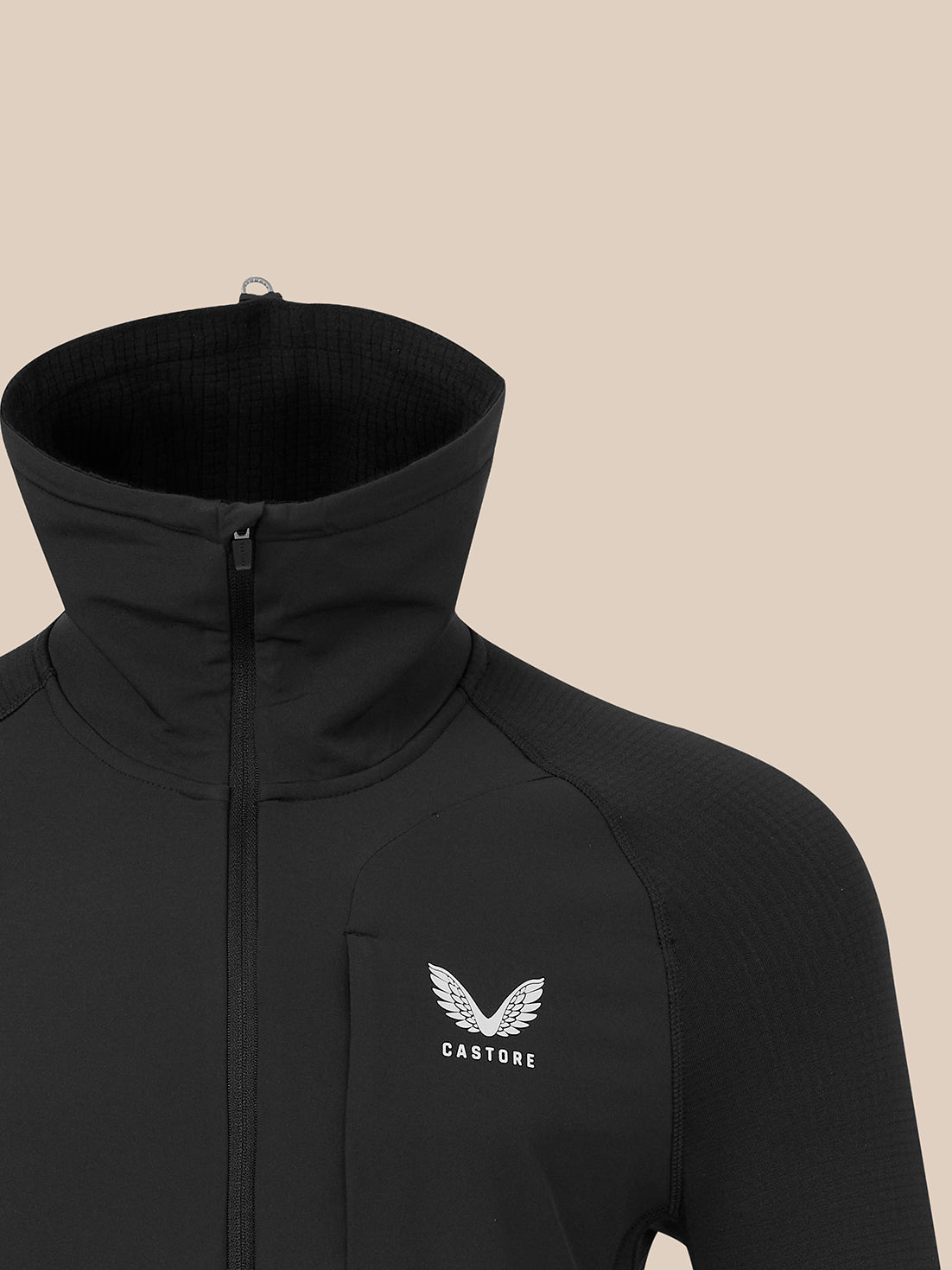 Close-up of black zip-front athletic top with high collar and left chest Castore logo.