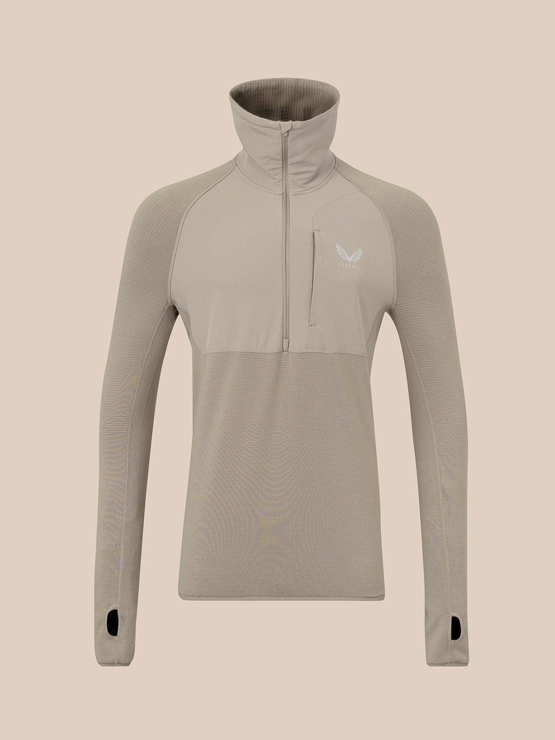 A long-sleeve quarter-zip pullover top in a light taupe-beige color, featuring a high mock neck collar, a vertical zippered chest pocket, and a small white wing logo on the left chest, displayed on a solid beige background.