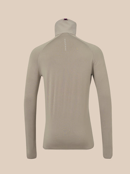 A light taupe long-sleeve mock neck athletic top shown from the back on a mannequin, against a solid beige background.