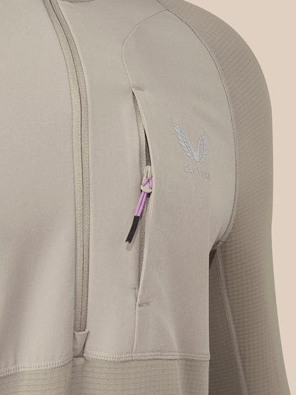 Close-up of a taupe men's slim fit thermo top showing a chest zipper and Castore logo