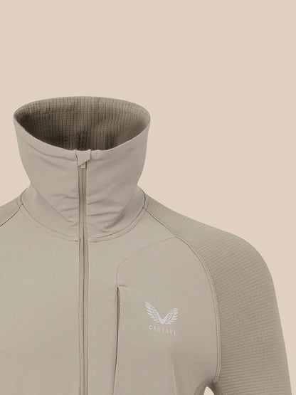 Taupe zip-front thermal jacket with funnel neck and raglan sleeves, Castore logo on chest.