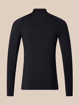 A black long-sleeve athletic top shown from the back, featuring a mock neck collar and raglan-style shoulder seams, set against a solid beige background.