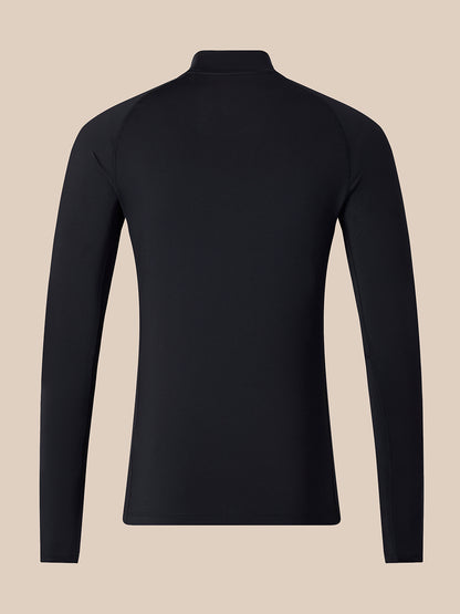 A black long-sleeve athletic top shown from the back, featuring a mock neck collar and raglan-style shoulder seams, set against a solid beige background.