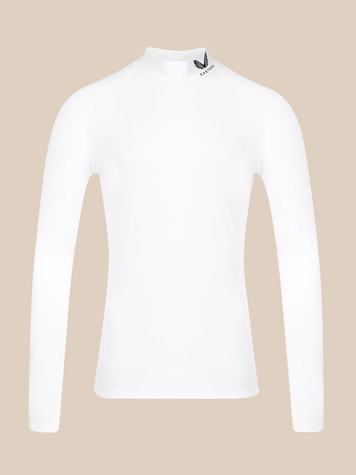 A white long-sleeve mock neck athletic top with a small black logo on the collar, displayed on a solid beige background.