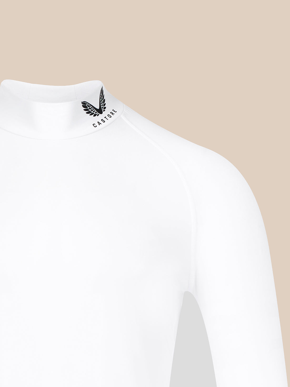 Close-up of a white long-sleeve mock-neck top with a black winged logo and the word 'CASTORE' printed on the inner neck, shown against a plain beige background.