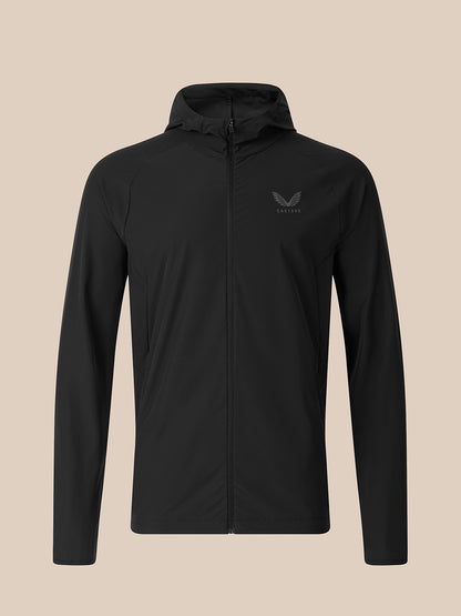 A black hooded zip-up jacket with a small dark gray wing logo on the left chest, displayed on a solid beige background.