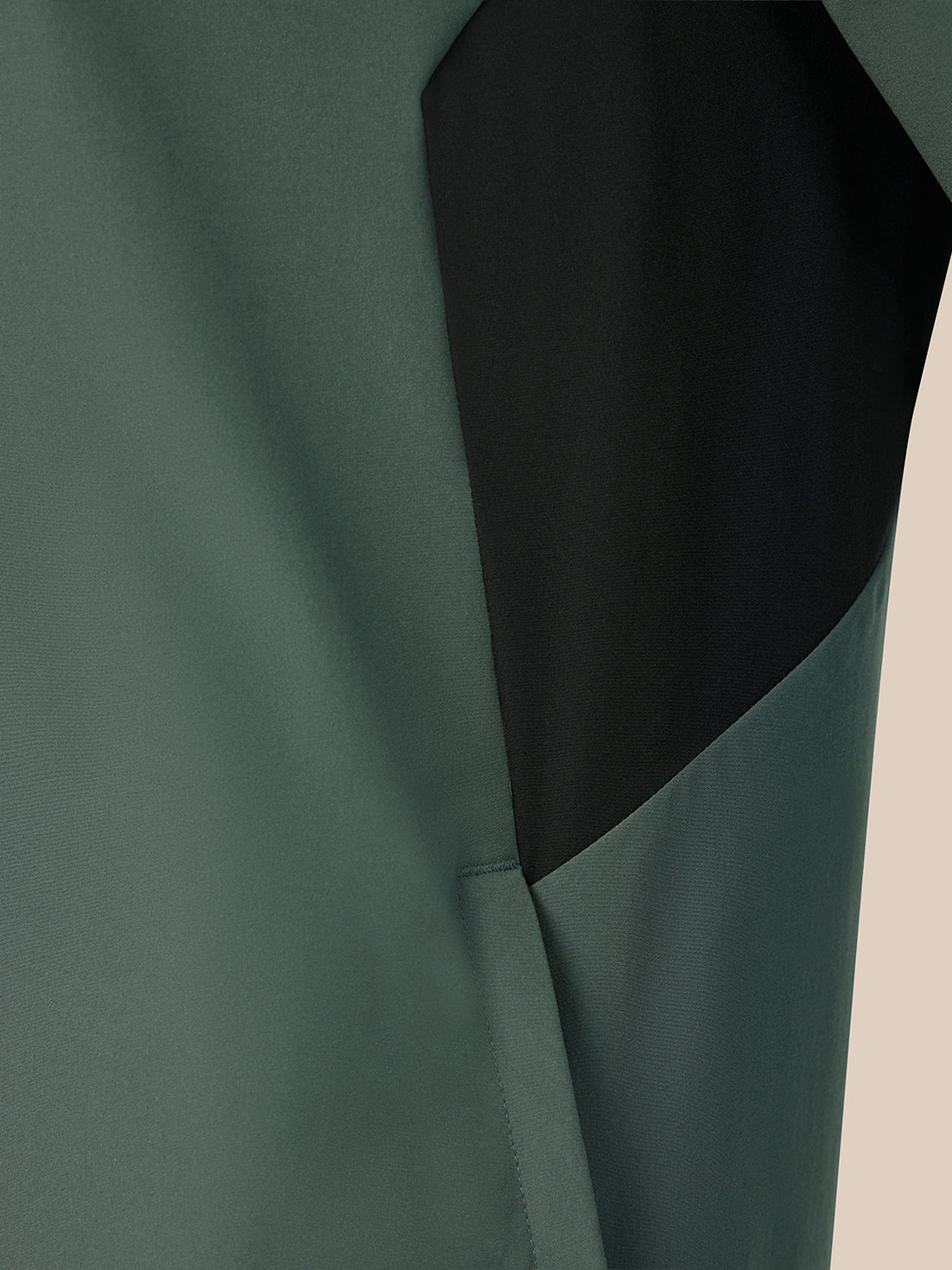 Dark green jacket on a beige background