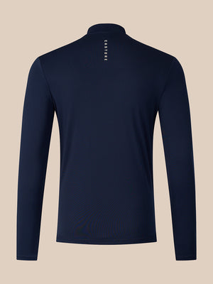 A navy blue long-sleeve quarter-zip pullover shown from the back, featuring a small vertical white 'CASTORE' logo printed on the upper back, set against a solid beige background.