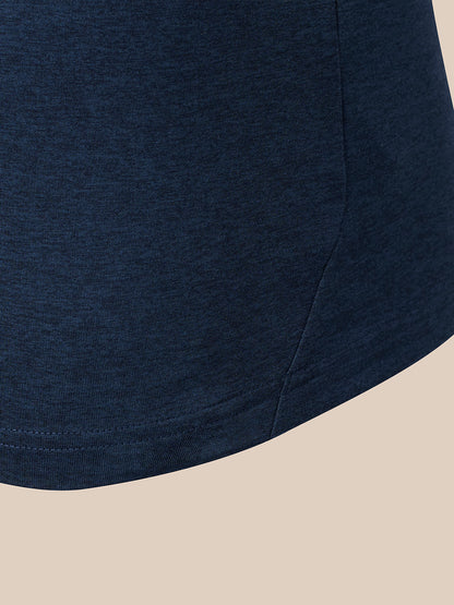 Close-up of a dark navy blue heathered fabric garment corner with a curved hem, shown against a light beige background.