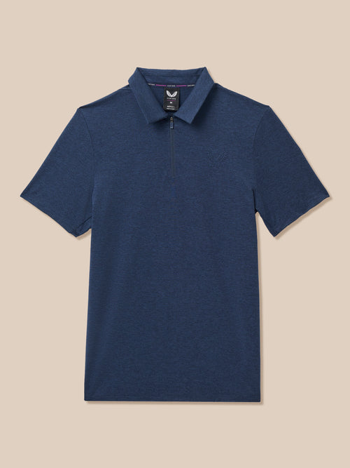 A navy blue short-sleeve polo shirt with a half-zip collar, displayed flat against a solid beige background.