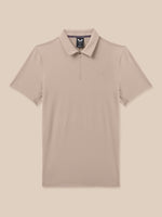 A short-sleeve polo shirt in a light taupe-beige color, featuring a half-zip collar and a small embroidered logo on the left chest, displayed against a solid beige background.