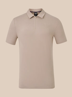 A short-sleeve polo shirt with a half-zip collar in a light taupe-beige color, shown against a solid beige background.