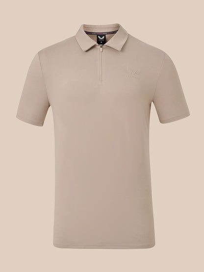 A short-sleeve polo shirt with a half-zip collar in a light taupe-beige color, shown against a solid beige background.