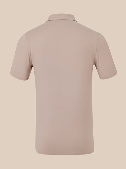 A short-sleeve polo shirt shown from the back, in a solid light taupe-beige color, displayed on a matching neutral beige background.