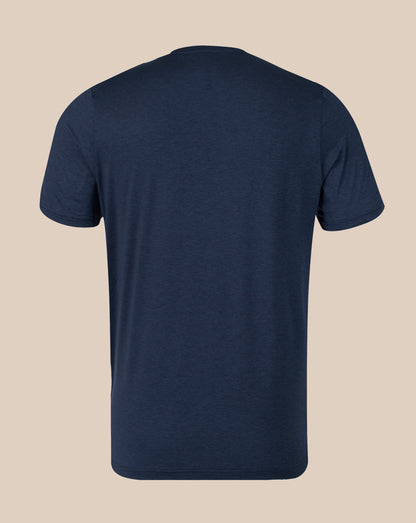 A navy blue short-sleeve crewneck t-shirt shown from the back, displayed on a solid beige background.