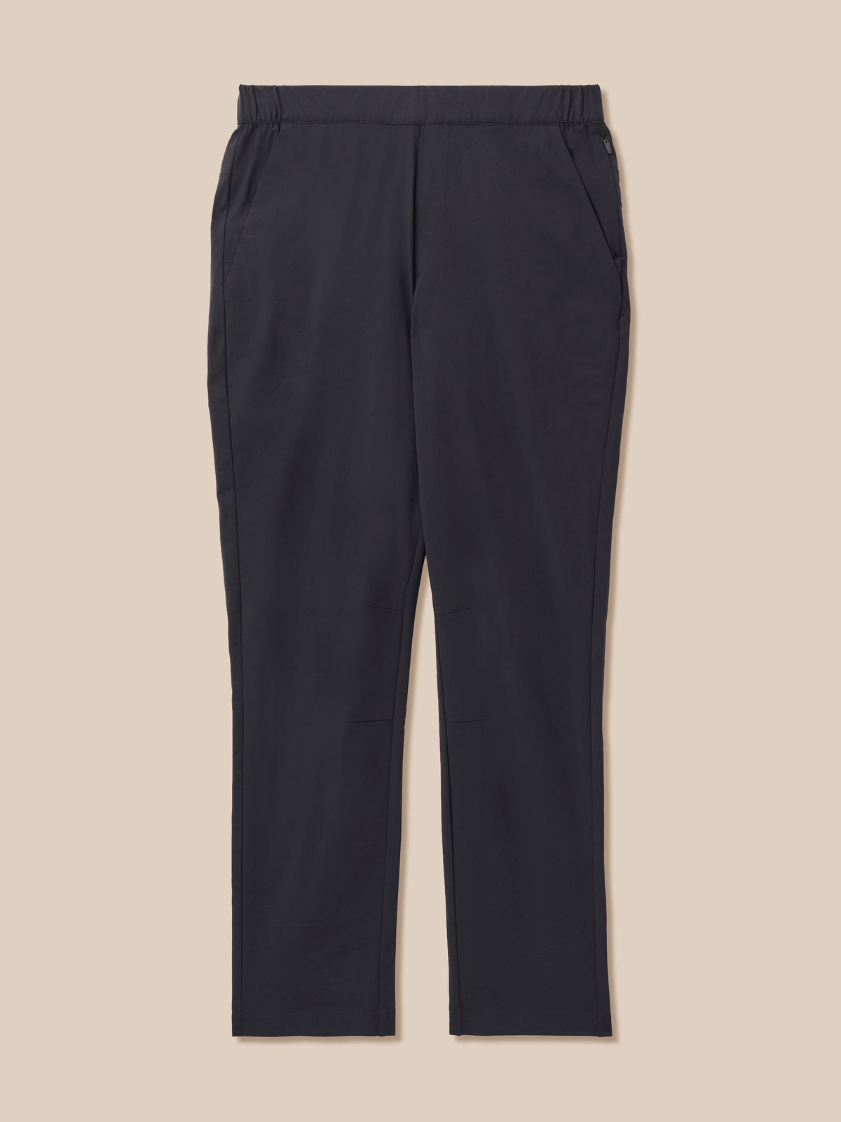 A pair of black trousers with an elastic waistband, displayed flat against a solid beige background.