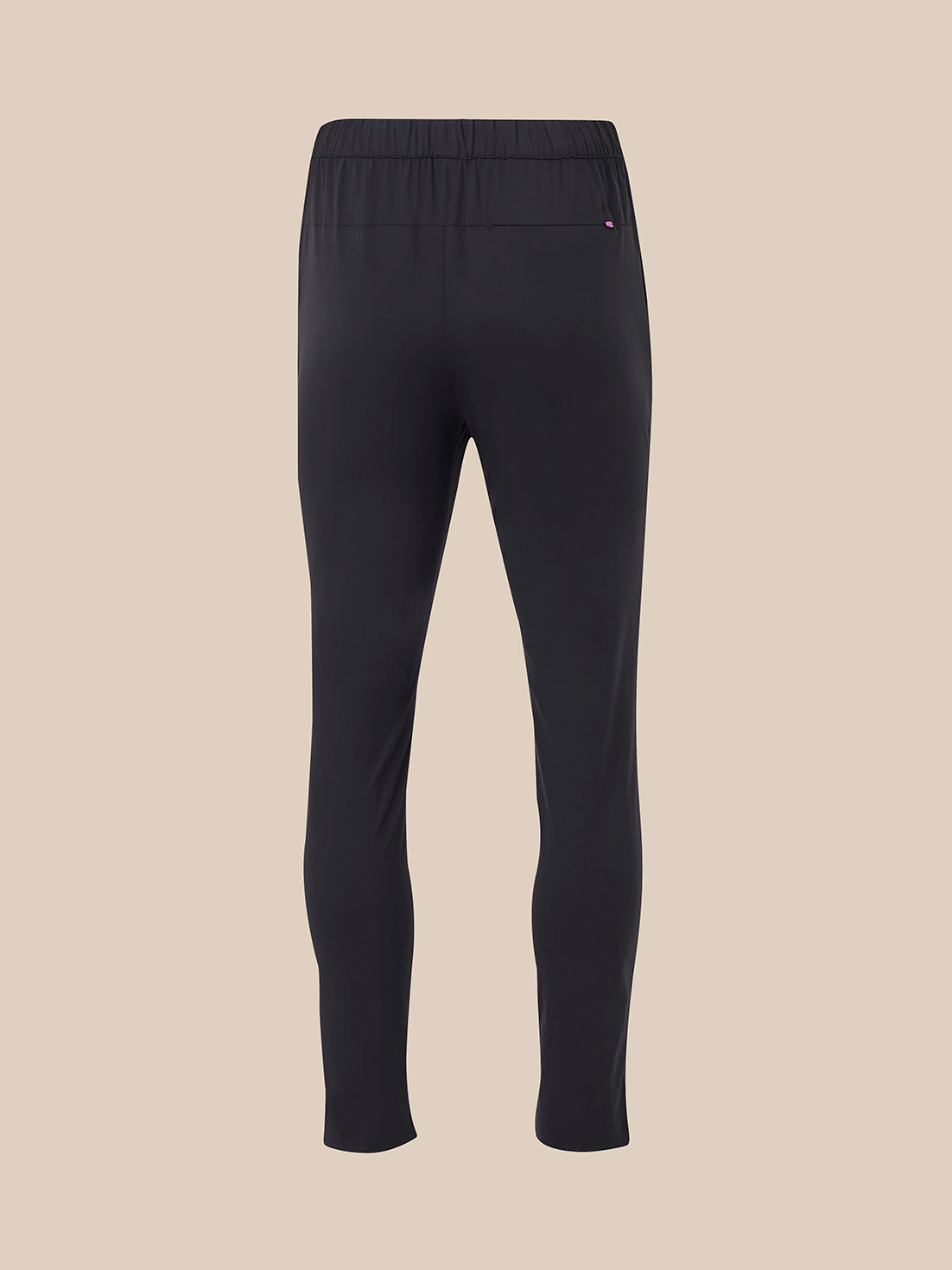 Back view of black elevated lifestyle slim fit trousers with elasticated waistband and back pocket with pink logo tab.
