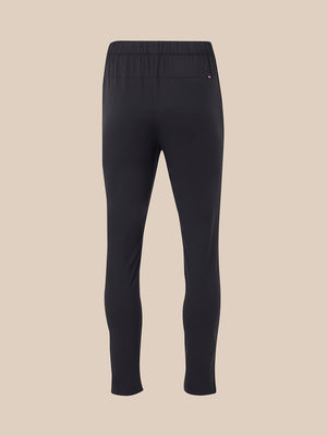 Back view of black elevated lifestyle slim fit trousers with elasticated waistband and back pocket with pink logo tab.