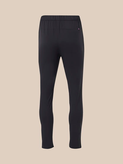 Back view of black elevated lifestyle slim fit trousers with elasticated waistband and back pocket with pink logo tab.