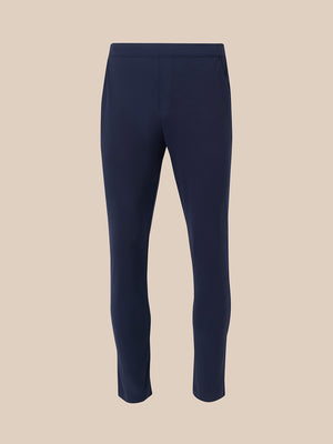 Back view of navy elevated lifestyle slim fit trousers with partially elasticated waistband and pink zip pull on rear pocket